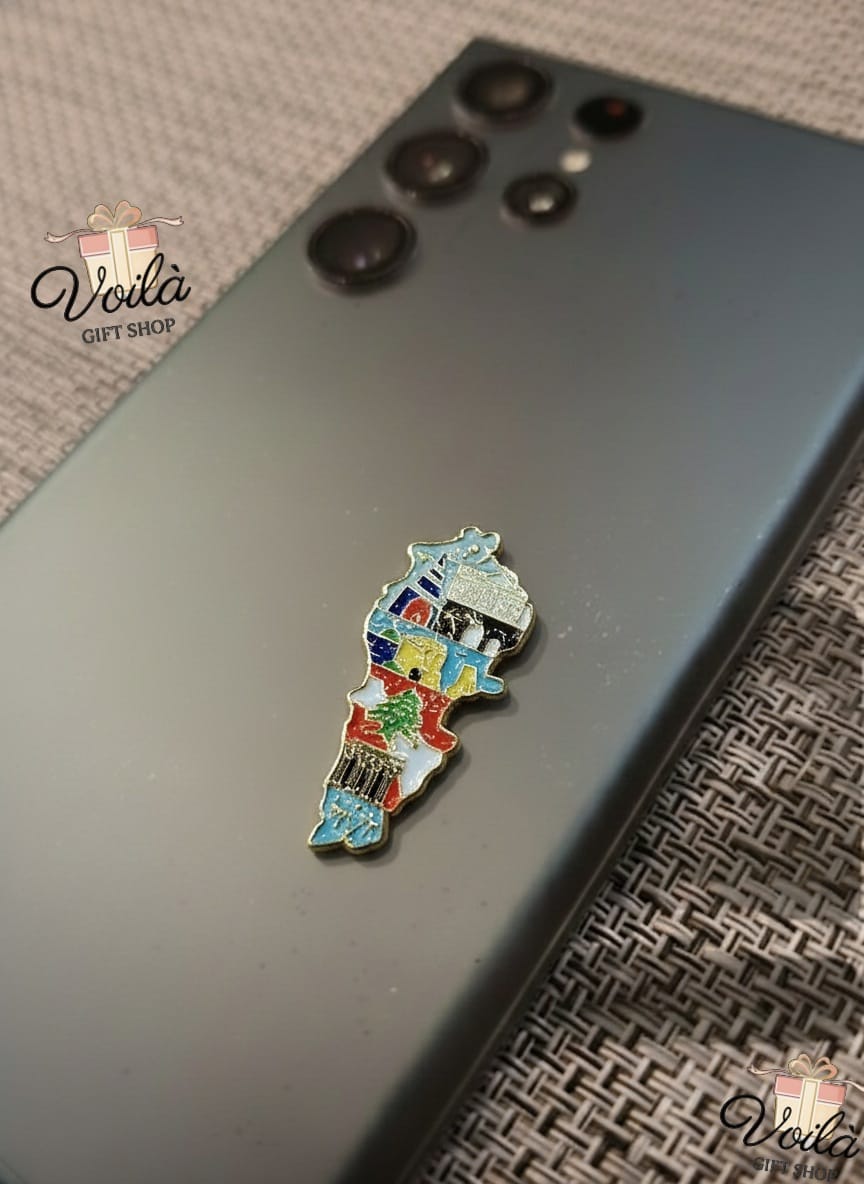 Colorful map pin on a phone case with 'Voila Gift Shop' branding.