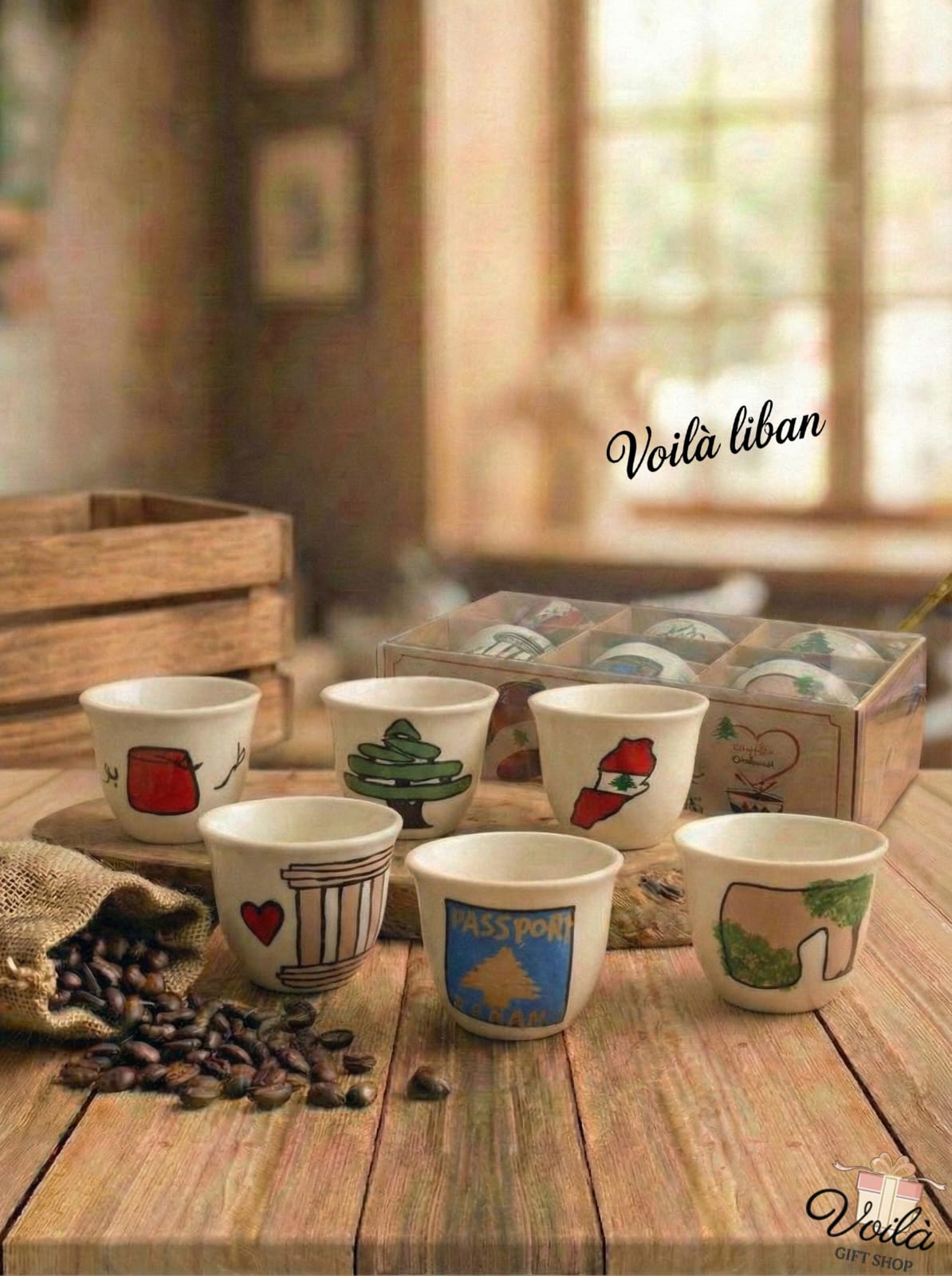 Set of ceramic cups with various designs on a wooden table, with 'Voila Liban' branding.