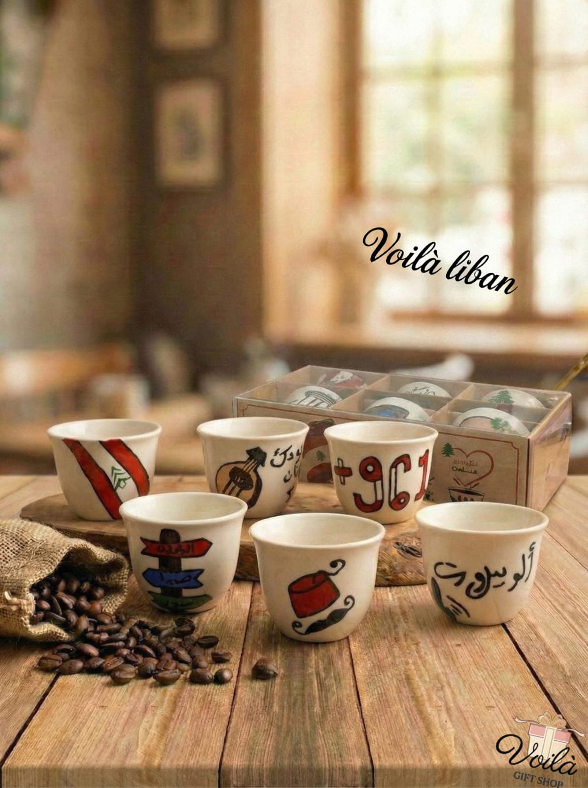 Set of hand-painted ceramic cups on a wooden table with 'Voila Liban' branding.