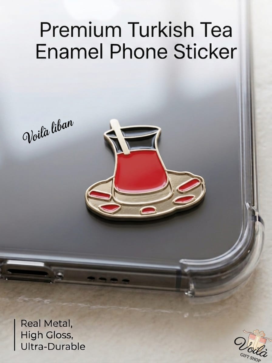 Premium metal enamel phone sticker shaped like a traditional Turkish tea glass (Istikan) filled with red tea on a gold saucer with red accents, featuring a small gold spoon, attached to a clear phone case.