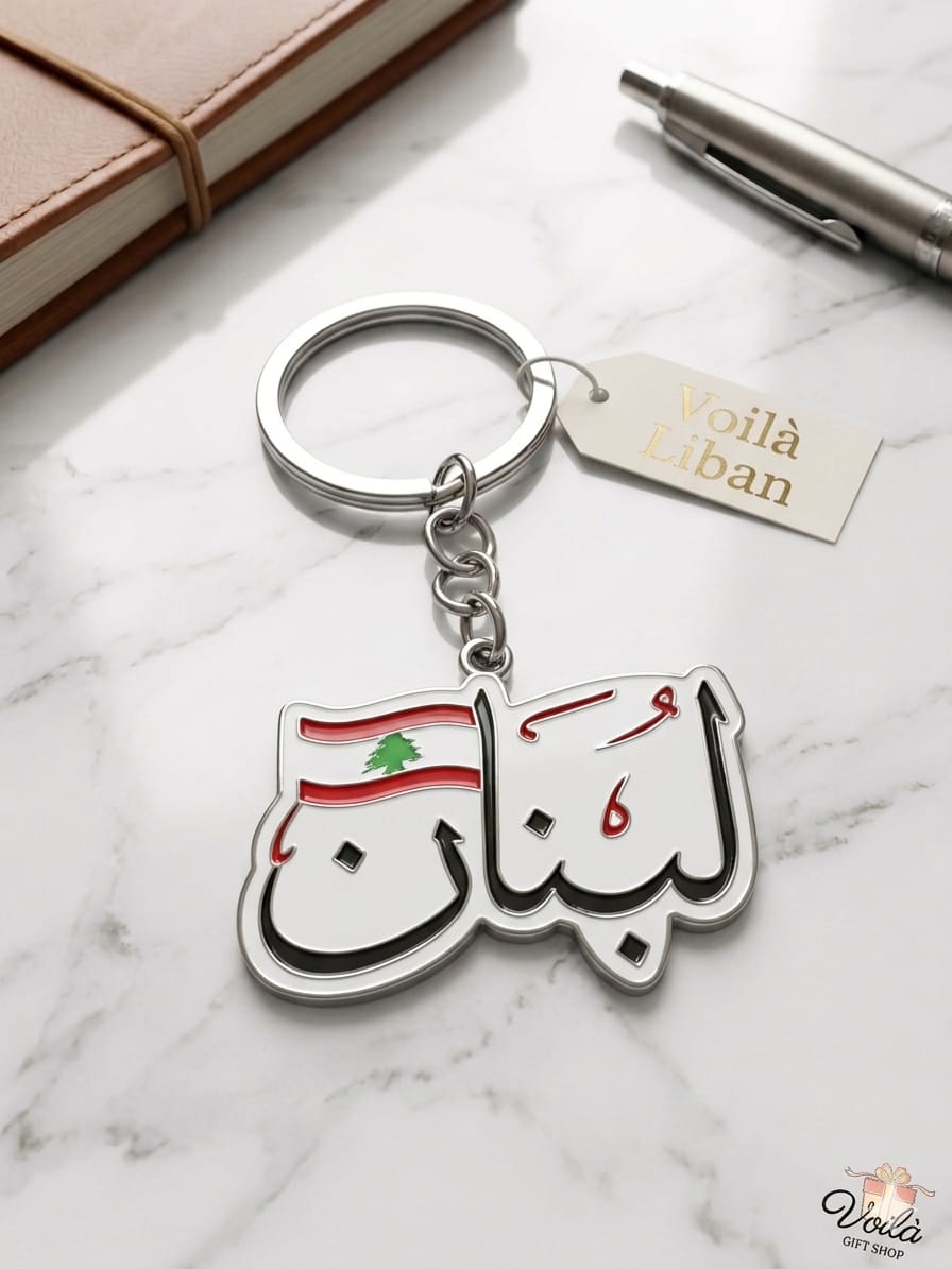 Keychain with Lebanese flag design and 'Voila Lebanon' branding on a marble surface.