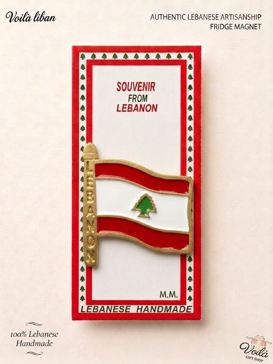 Authentic 100% handmade Lebanese fridge magnet featuring a waving enamel national flag attached to a gold flagpole engraved with the word Lebanon, in premium souvenir packaging.