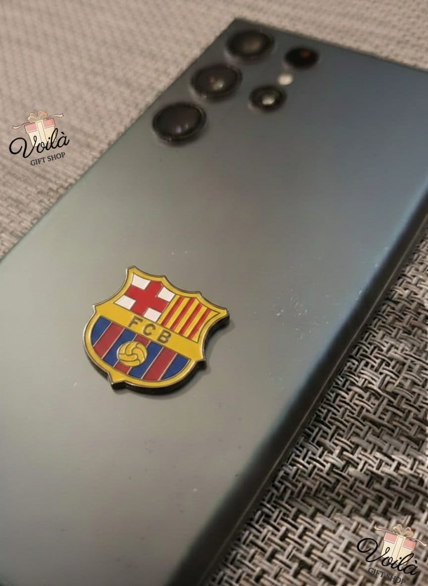 Phone case with FC Barcelona logo on a textured surface