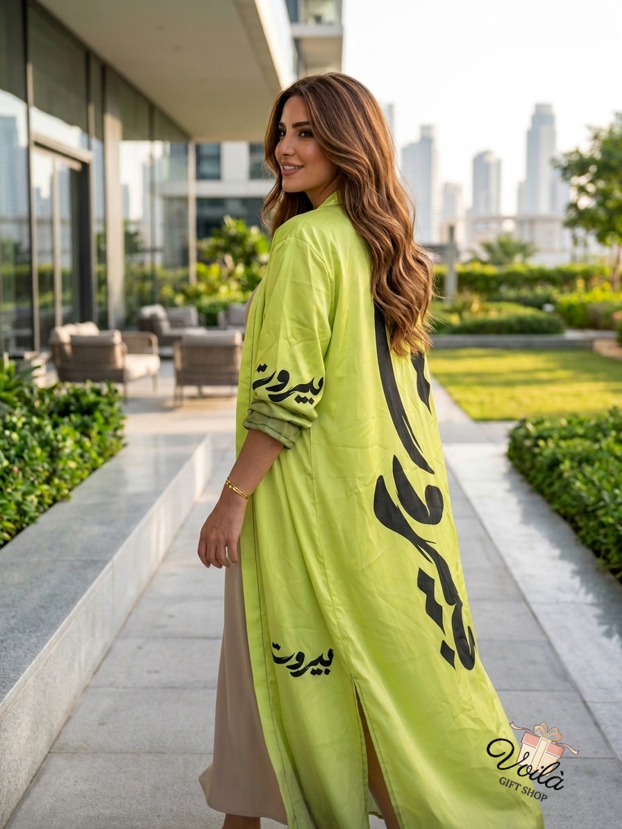 Woman wearing a lime green abaya with Arabic calligraphy of Beirut