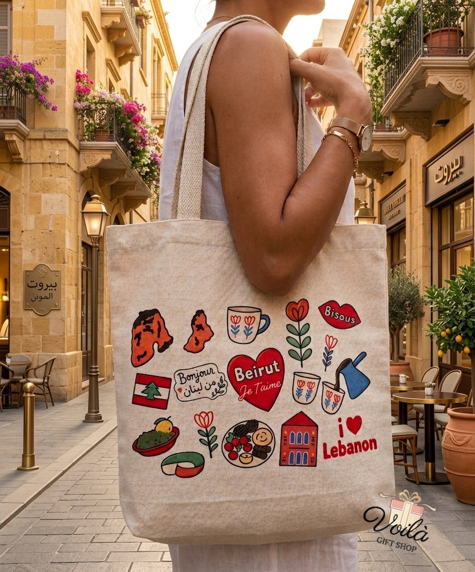 Woman holding a canvas tote bag decorated with colorful Lebanese heritage doodles on a sunny Beirut street