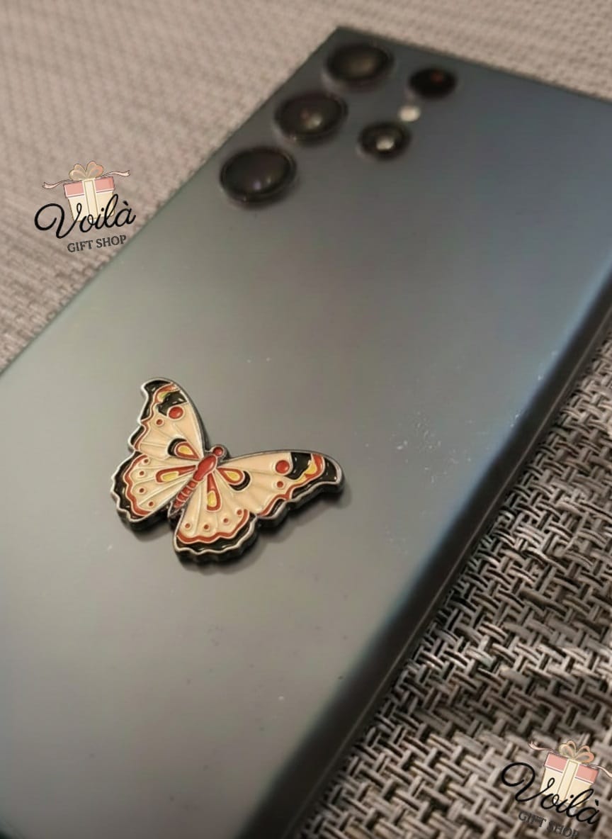 Butterfly-shaped phone case on a smartphone with 'Veila' branding.