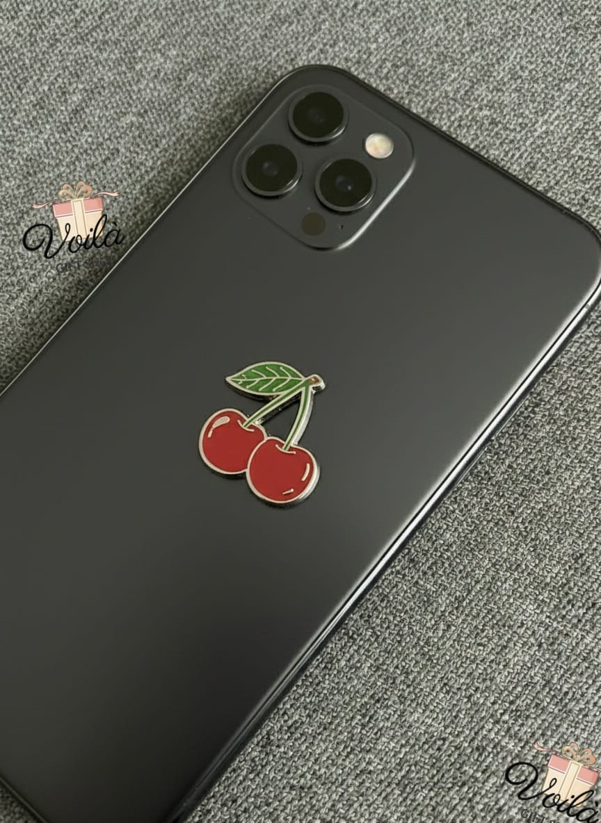 Black phone case with cherry design on a gray surface