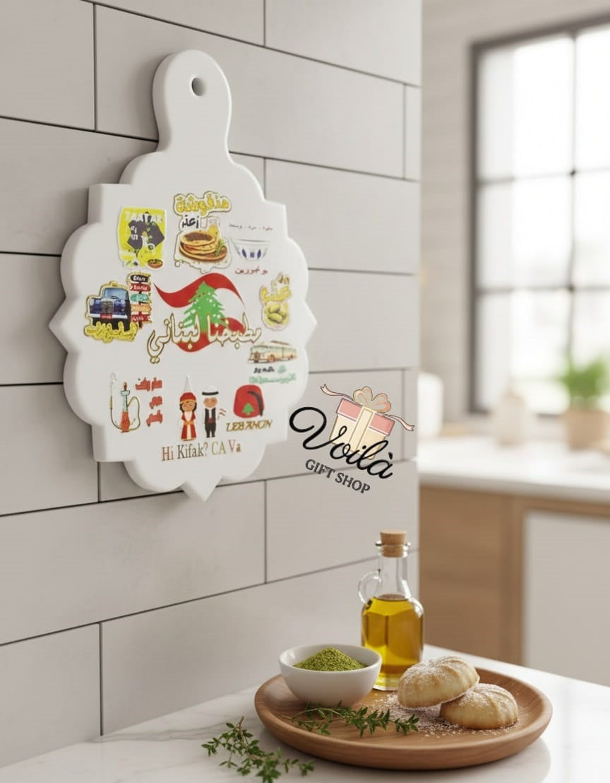 Decorative cutting board with illustrations and text on a kitchen counter.
