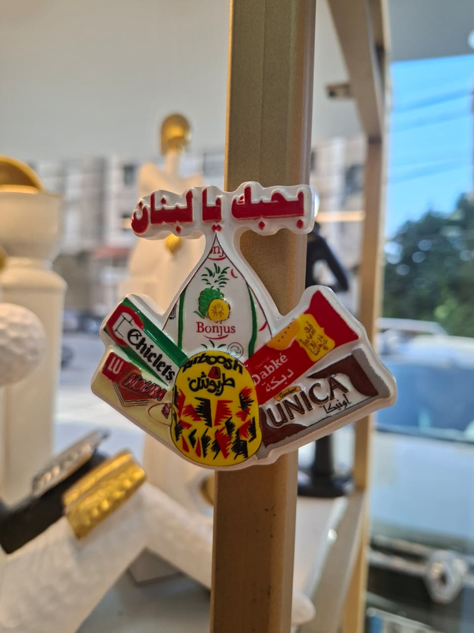 Decorative sign with various brand logos on a wooden stand