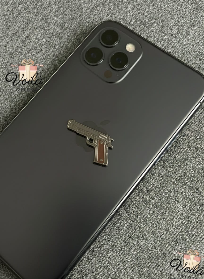 Phone case with a gun-shaped design on a textured surface