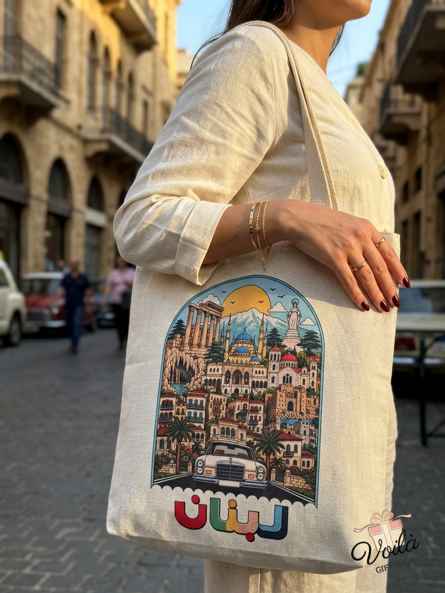 Woman carrying a canvas tote bag featuring colorful illustrations of Lebanese landmarks and Arabic text
