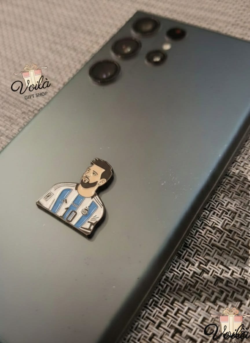Phone case with a pin of a person in a sports jersey on a textured surface