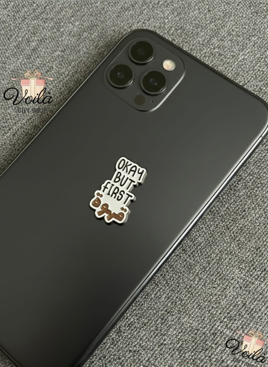 Phone case with 'Okay But First' design on a textured surface