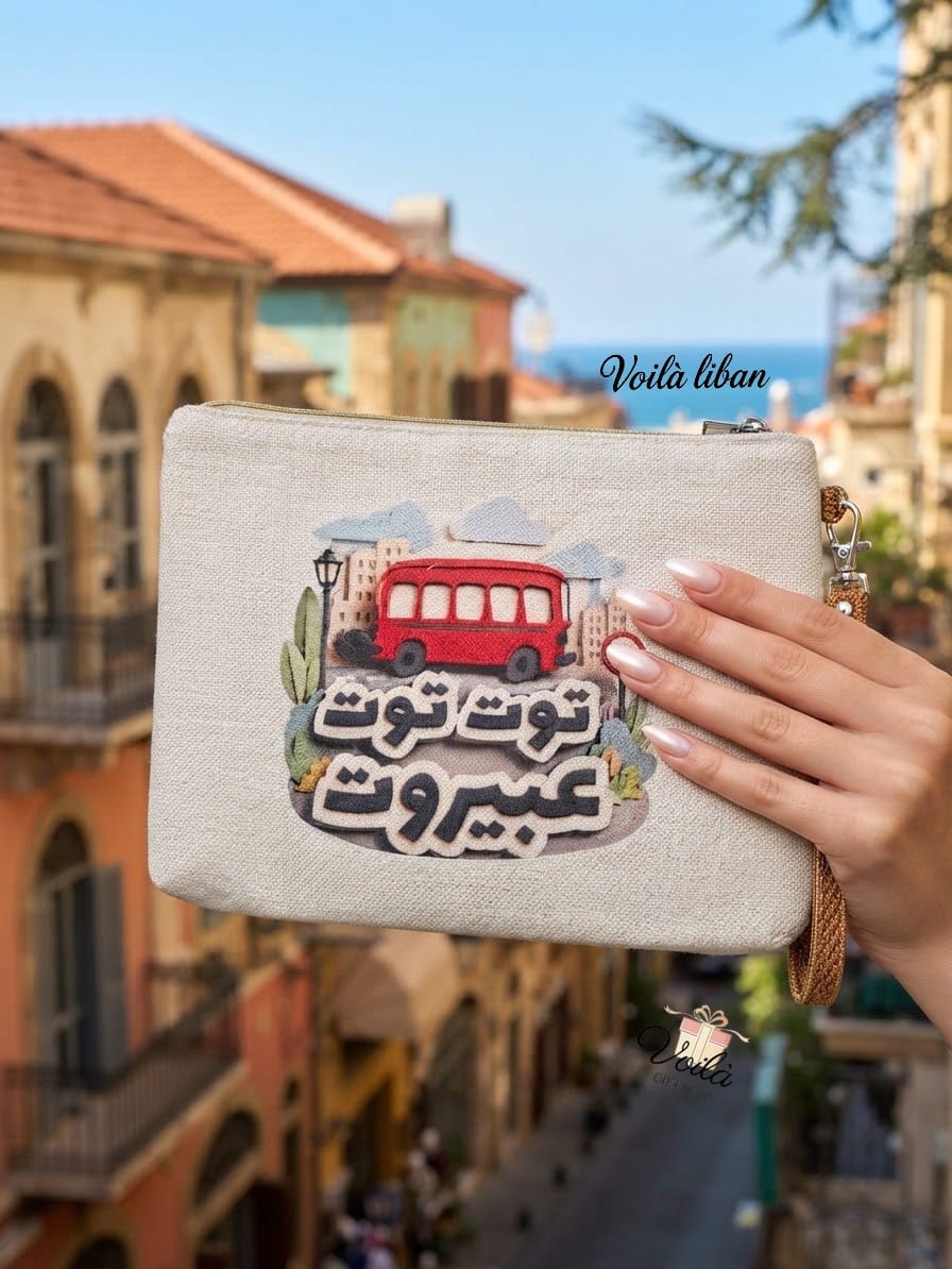 Embroidered canvas pouch featuring the red bus and Arabic text Toot Toot a Beirut
