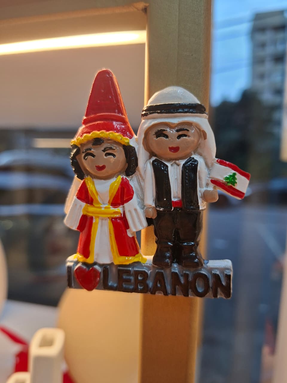 Decorative figurine of a couple in traditional Lebanese attire with 'I ❤️ Lebanon' text.