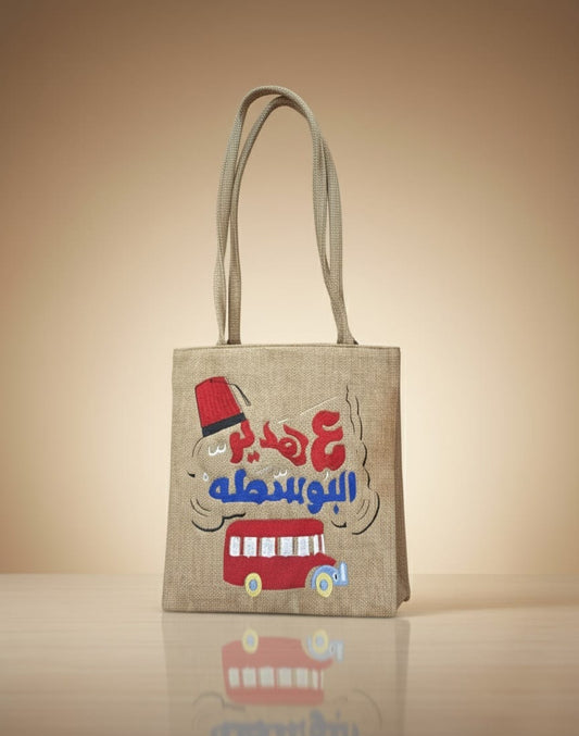 Tote bag with a graphic design on a reflective surface and beige background
