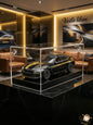 Model car in a clear display case on a marble surface with 'Voila liban' branding in the background.