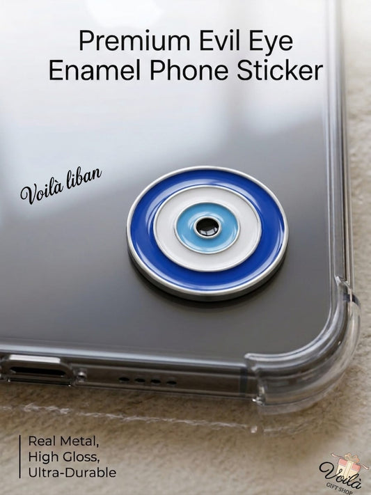 Premium round blue metal enamel phone sticker designed as a traditional evil eye (Nazar) with concentric circles of dark blue, white, light blue, and a black center, attached to a clear phone case.