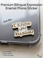 Premium white and gold metal enamel phone sticker featuring a humorous Lebanese bilingual phrase that reads "I Know" in English, followed by the Arabic text "بس بستعبط" (bas basta3bet), affixed to a clear phone case.