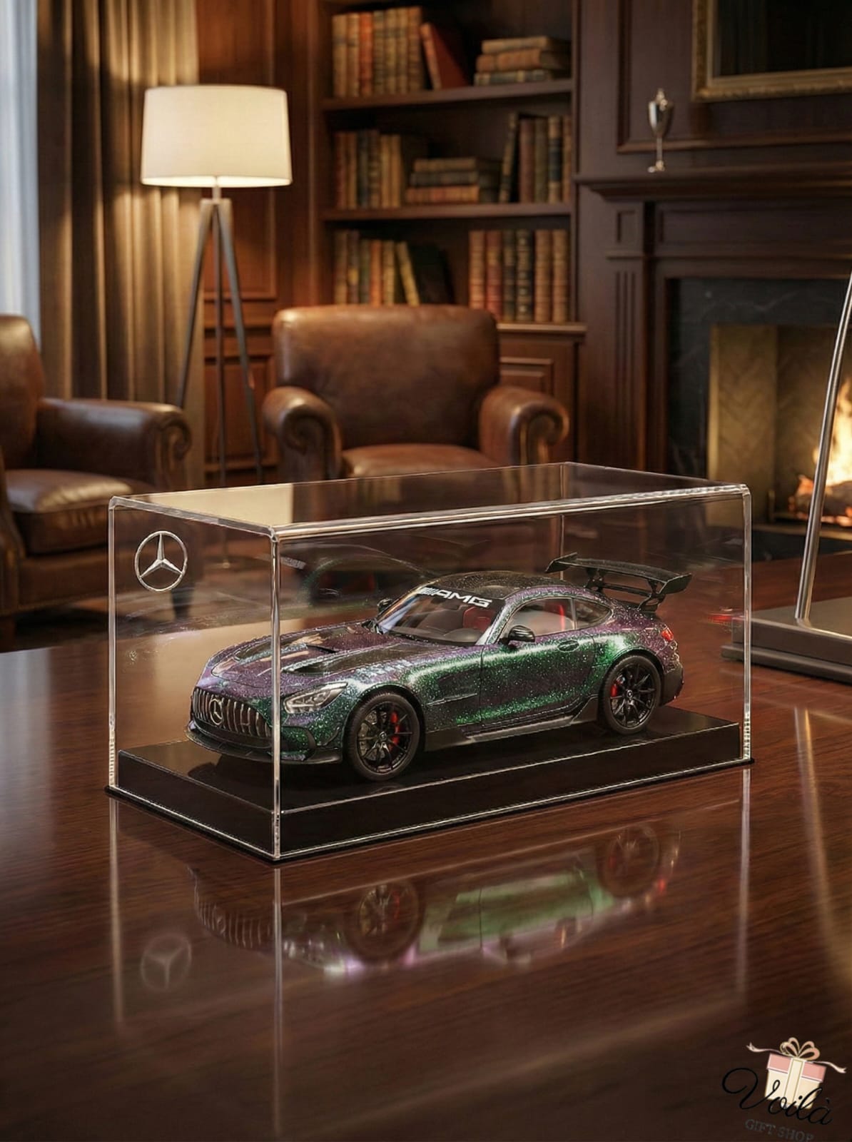Model car in a clear display case on a wooden table with a cozy room background