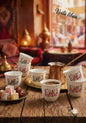 Café setting with cups, coffee, and Turkish delight on a wooden table with 'Voila Liban' branding.