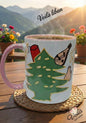 Mug with a design of a tree and people on a wooden table with a scenic background