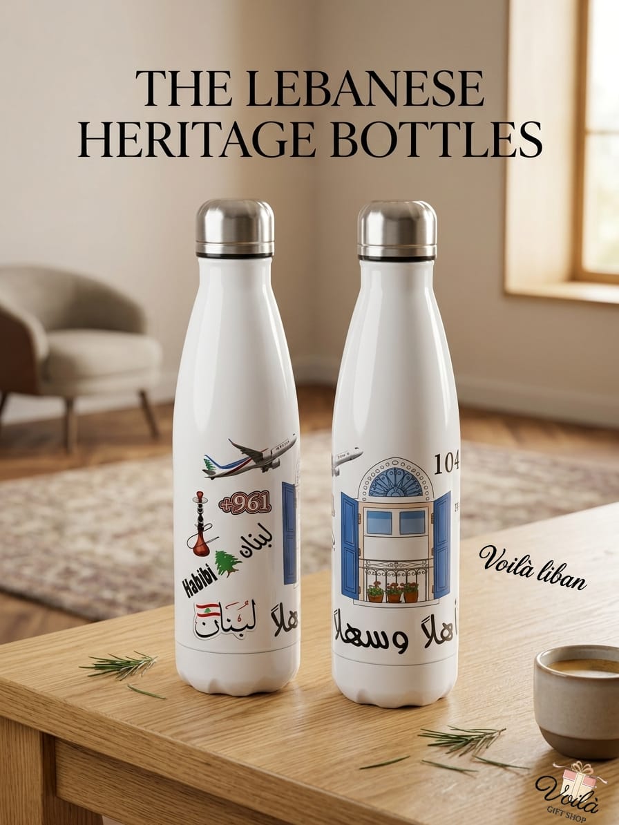 Two white bottles with Lebanese design elements on a wooden table.