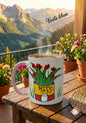 Mug with floral design on a wooden table with mountains in the background