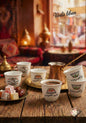 Café set with cups and a tray on a wooden table, featuring 'Voila liban' branding.