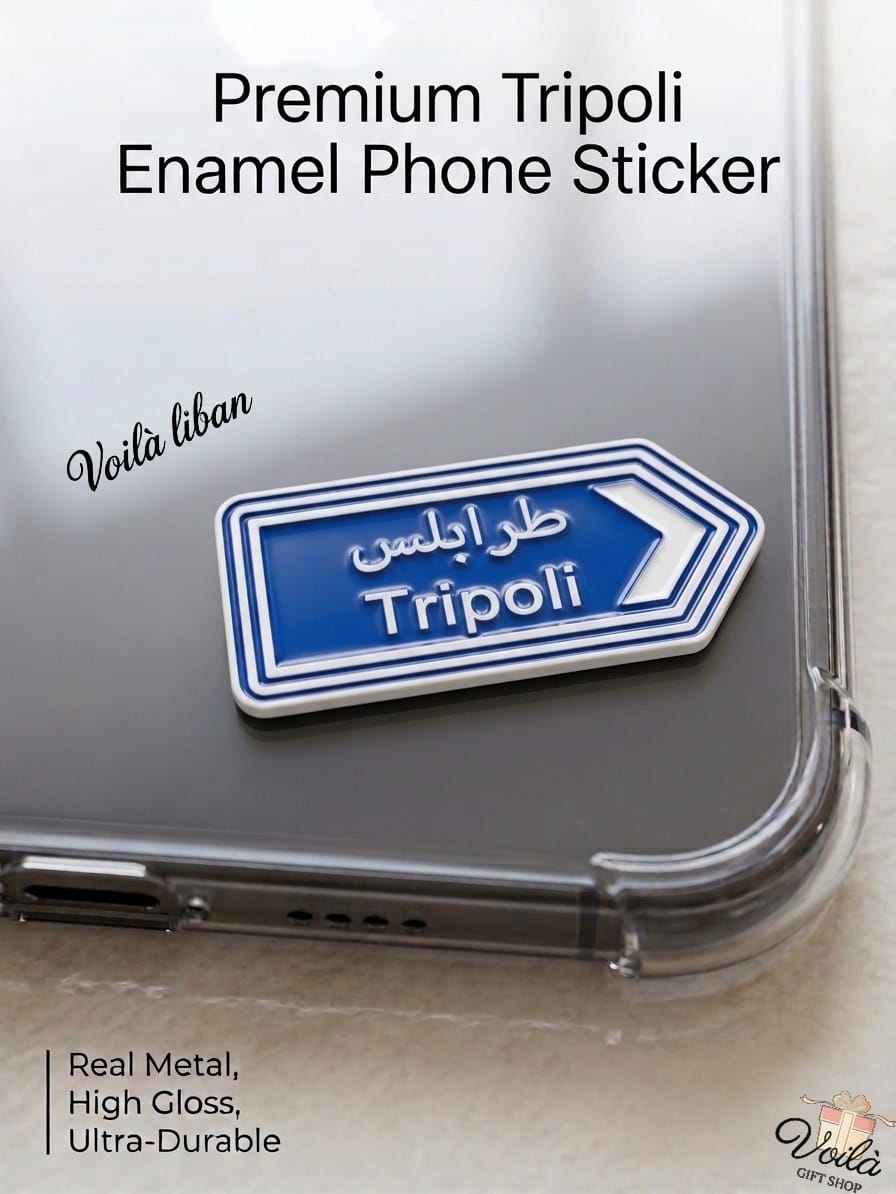 Premium blue metal enamel phone sticker shaped like a Lebanese street sign pointing right, featuring the text "Tripoli" in English and the Arabic script (طرابلس), attached to a clear phone case.