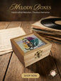 Wooden melody box with a decorative lid on a wooden surface with music sheets and records.