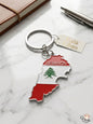 Keychain shaped like the map of Lebanon with the Lebanese flag on a marble surface.