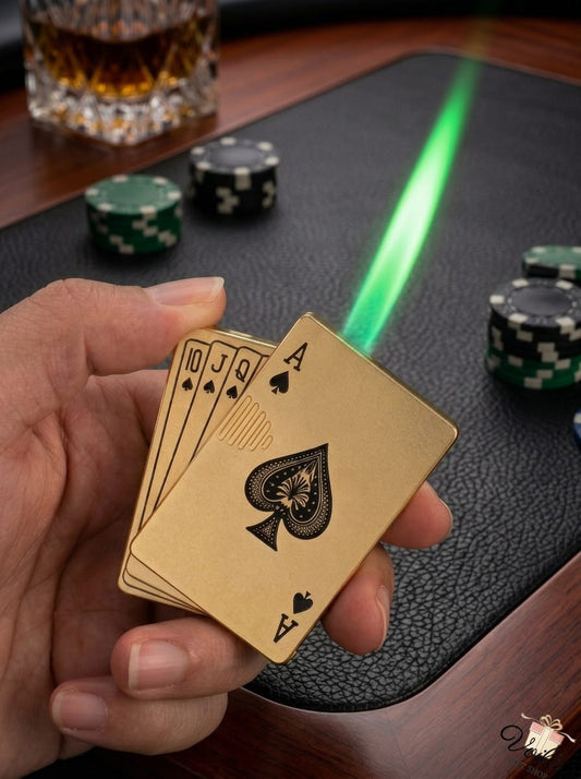 Hand holding gold playing cards with poker chips and a glass of whiskey on a table.