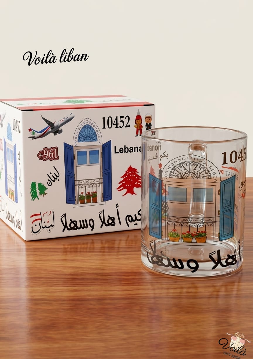 Glass with decorative design and matching box on a wooden surface, featuring 'Voila Liban' branding.