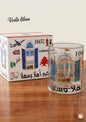 Glass with decorative design and matching box on a wooden surface, featuring 'Voila Liban' branding.