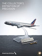 Model airplane on a stand with 'American Airlines' branding against a gray background