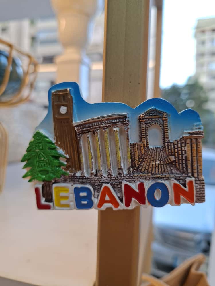 Fridge magnet with architectural design and 'Lebanon' text on a stand.