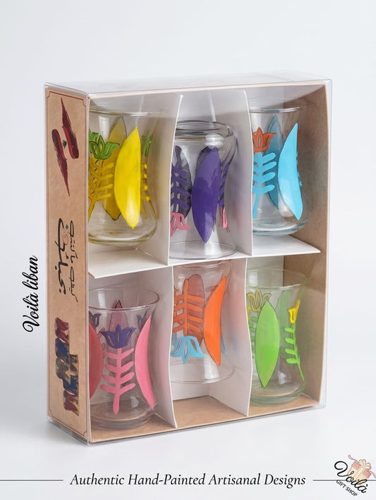Set of six authentic hand-painted Lebanese glass tea cups featuring vibrant botanical designs in yellow, purple, blue, pink, orange, and green, presented in a premium display box.