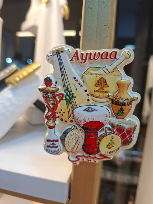 Decorative item with musical instruments and 'Aywaa' branding on a stand.