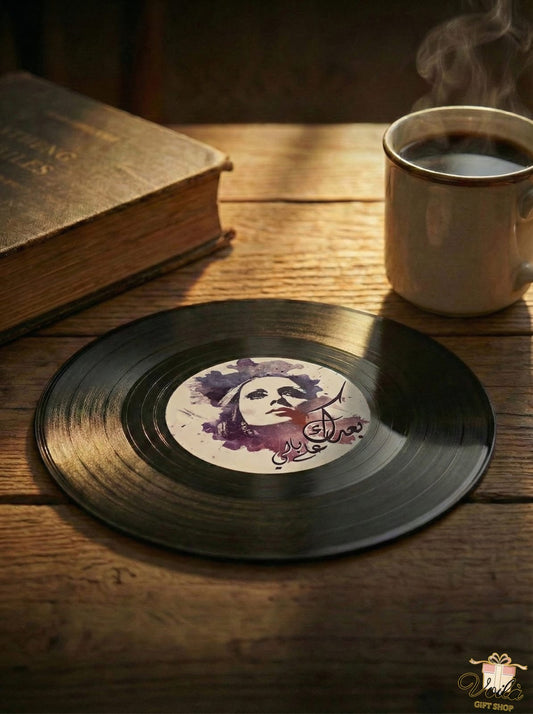 Vinyl record with a face illustration on a wooden table with a cup of coffee and a book.