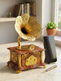 Vintage gold and wood gramophone music box on a marble table