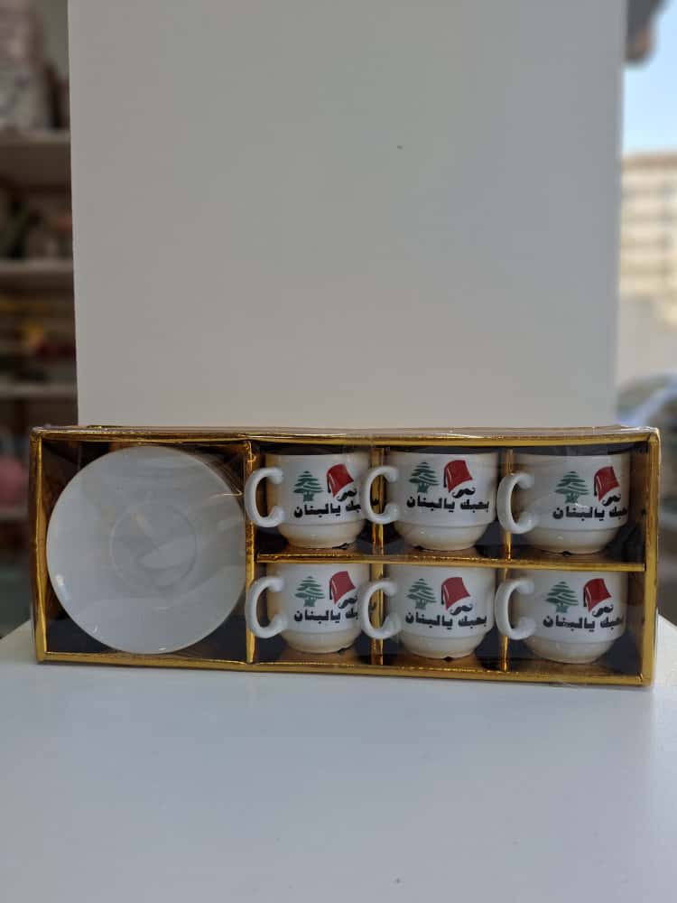 Set of six mugs with a logo in a box on a white surface