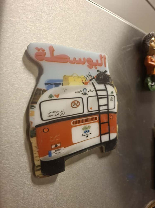 Fridge magnet with a colorful design of a vehicle on a metallic surface
