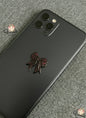 Phone case with a decorative bow on a textured surface