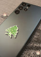 Phone case with a green leaf design on a textured surface