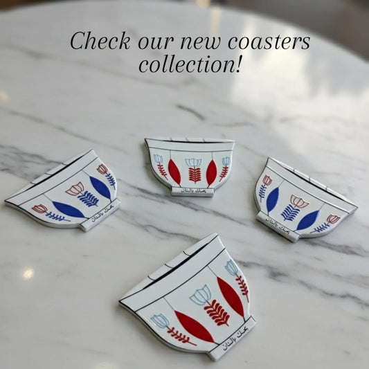 Decorative coasters with floral patterns on a marble surface, with text 'Check our new coasters collection!'.