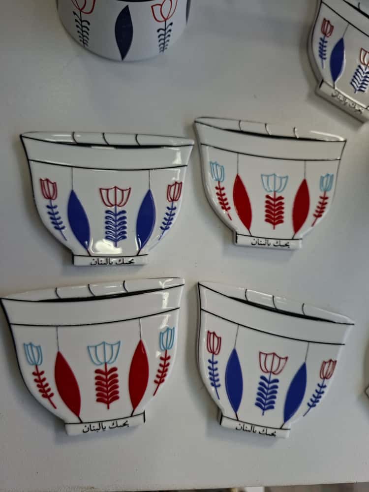 Set of ceramic wall bowls with floral designs on a white background
