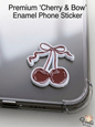 Premium Cherry and Bow enamel phone sticker on a clear phone case