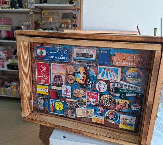 Wooden frame with various colorful stickers and labels on a shelf.