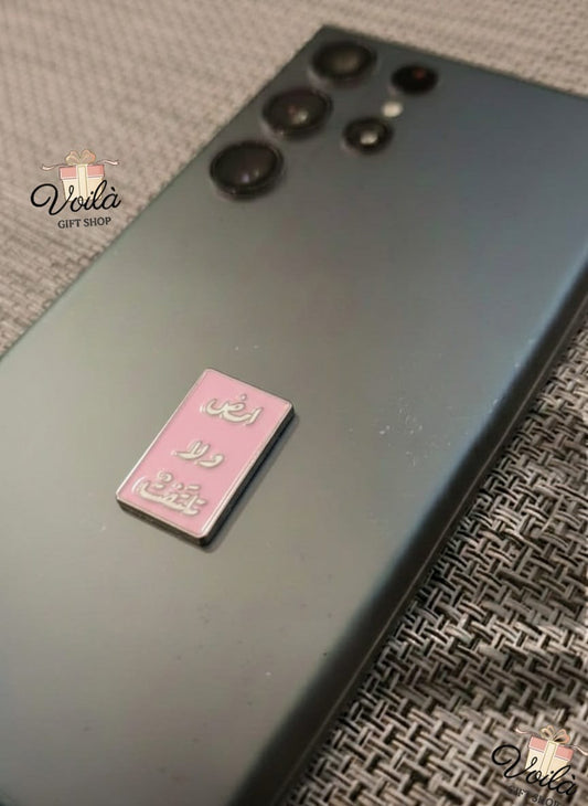 Black smartphone with a pink card on a textured surface